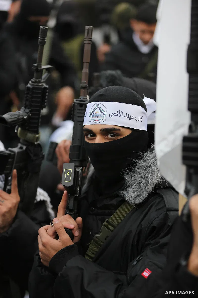 Palestinian gunmen from the Balata Brigade of the Fatah movement carry their weapons and show off their strength, during a memorial ceremony of the Palestinian Mahdi Hashash who was killed by the Israeli army at the Bala...