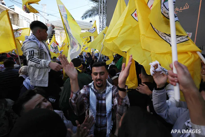 Palestinian supporters of the Fatah movement take part during a rally marking the 58th anniversary of the creation of the political party, in the West Bank city of Ramallah, on December 29, 2022. Photo by Wajed Nobani