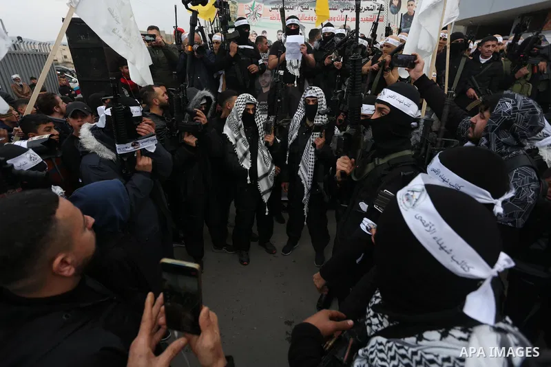 Palestinian gunmen from the Balata Brigade of the Fatah movement carry their weapons and show off their strength, during a memorial ceremony of the Palestinian Mahdi Hashash who was killed by the Israeli army at the Bala...