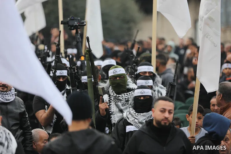 Palestinian gunmen from the Balata Brigade of the Fatah movement carry their weapons and show off their strength, during a memorial ceremony of the Palestinian Mahdi Hashash who was killed by the Israeli army at the Bala...