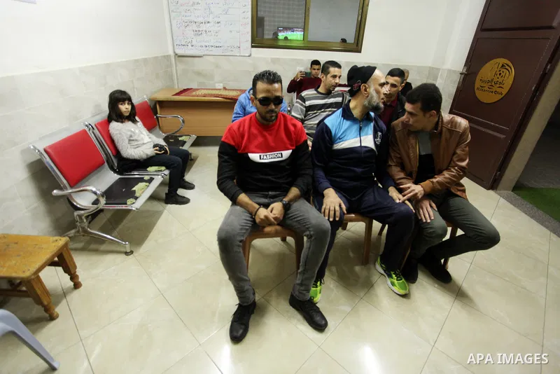 Palestinians listen to TV during the match between Morocco VS Canada, in the Qatar World Cup FIFA 2022, in Gaza city on December 1, 2022. There are at least 130,000 Palestinian people aged 50 years and older who live wit...