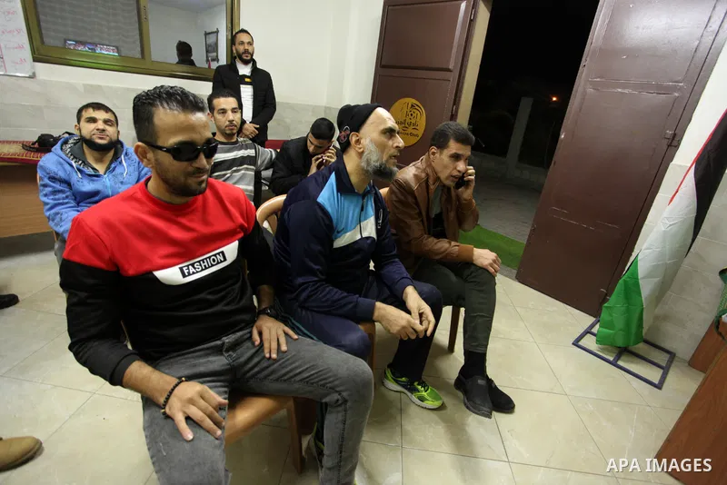 Palestinians listen to TV during the match between Morocco VS Canada, in the Qatar World Cup FIFA 2022, in Gaza city on December 1, 2022. There are at least 130,000 Palestinian people aged 50 years and older who live wit...