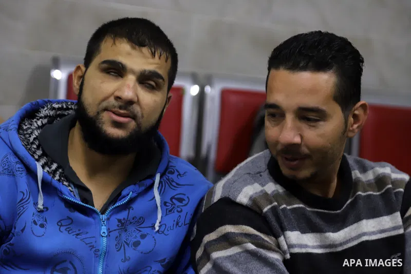 Palestinians listen to TV during the match between Morocco VS Canada, in the Qatar World Cup FIFA 2022, in Gaza city on December 1, 2022. There are at least 130,000 Palestinian people aged 50 years and older who live wit...