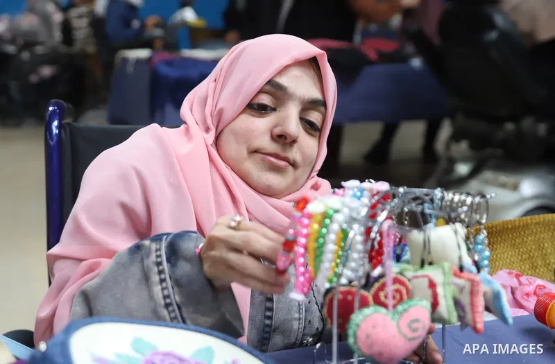 Palestinian women with disabilities Rana, 35, and Randa, 39 Ashour suffer from Fanconi syndrome display their products at an exhibition on the occasion of the International Day of Disabled Persons in Gaza city on Decembe...