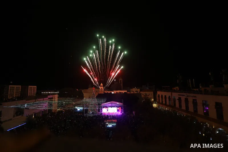 Palestinians light Christmas tree in Manger Square outside the Church of the Nativity in the West Bank city of Bethlehem on December 3, 2022. Christmas is an annual festival commemorating the birth of Jesus Christ, obser...
