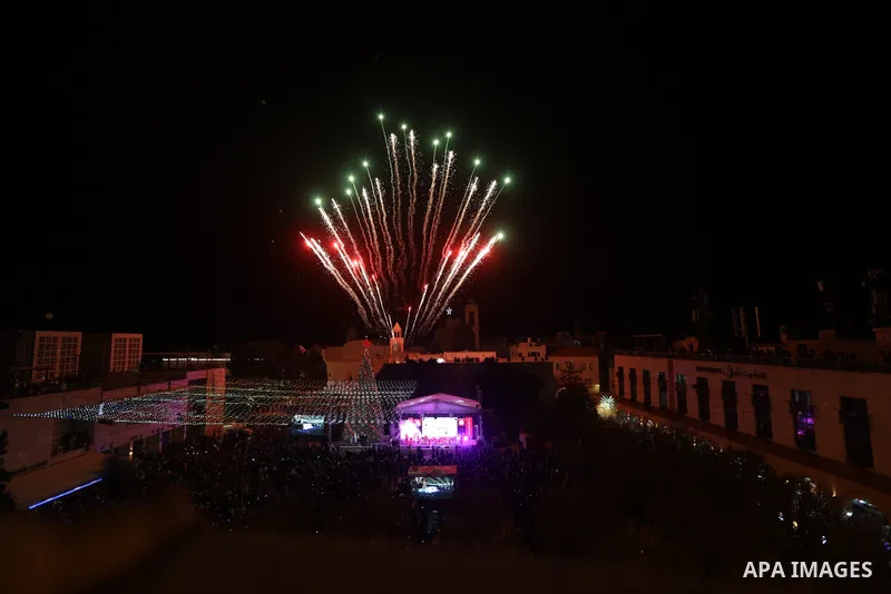 Palestinians light Christmas tree in Manger Square outside the Church of the Nativity in the West Bank city of Bethlehem on December 3, 2022. Christmas is an annual festival commemorating the birth of Jesus Christ, obser...