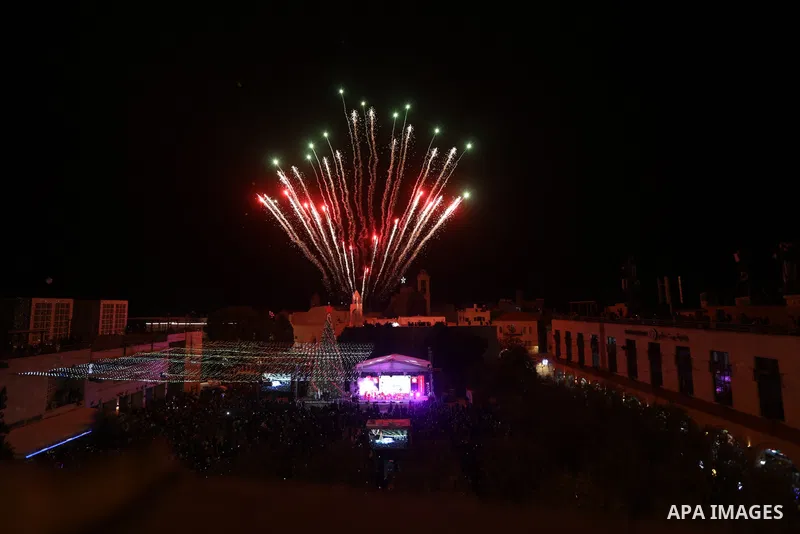 Palestinians light Christmas tree in Manger Square outside the Church of the Nativity in the West Bank city of Bethlehem on December 3, 2022. Christmas is an annual festival commemorating the birth of Jesus Christ, obser...