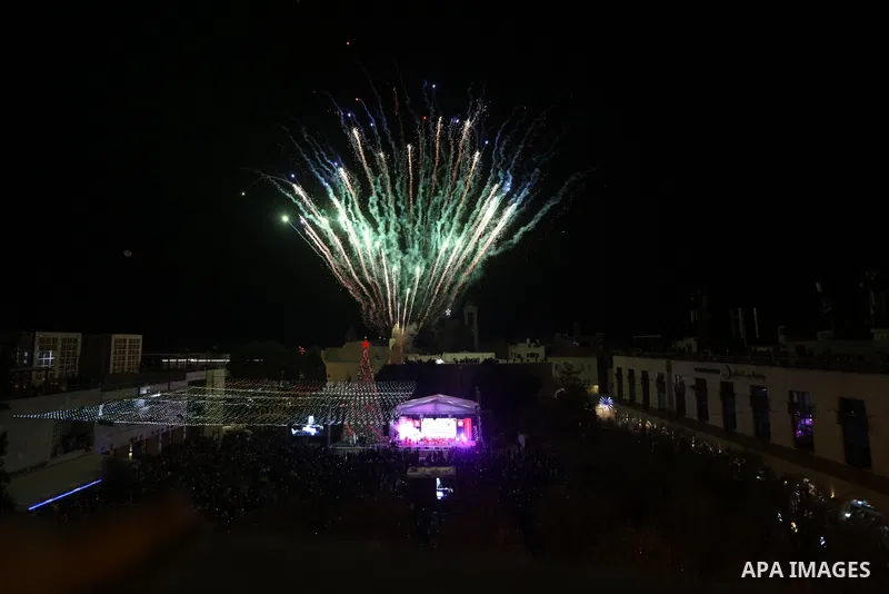 Palestinians light Christmas tree in Manger Square outside the Church of the Nativity in the West Bank city of Bethlehem on December 3, 2022. Christmas is an annual festival commemorating the birth of Jesus Christ, obser...