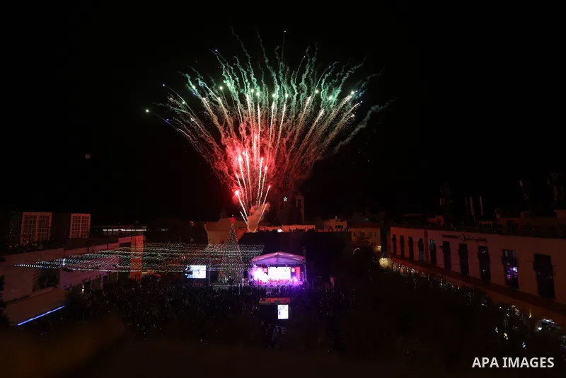 Palestinians light Christmas tree in Manger Square outside the Church of the Nativity in the West Bank city of Bethlehem on December 3, 2022. Christmas is an annual festival commemorating the birth of Jesus Christ, obser...