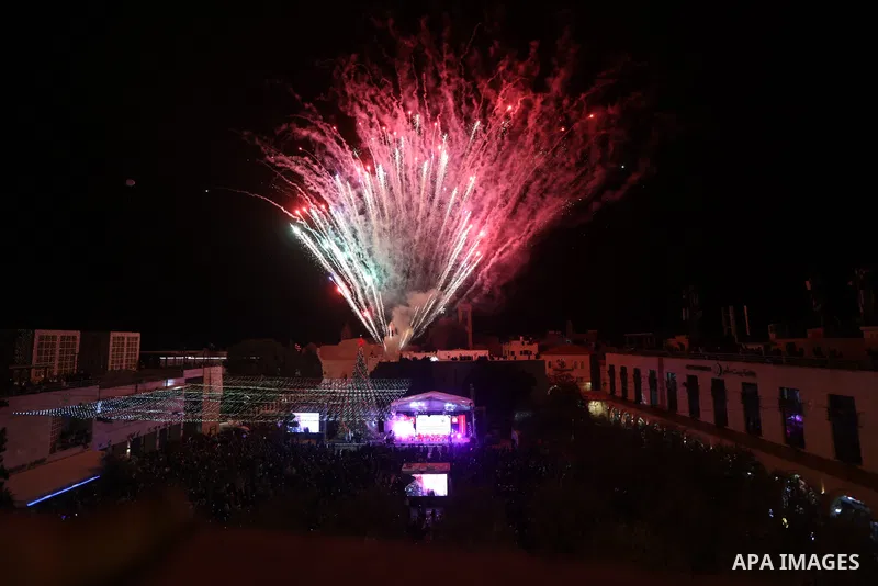 Palestinians light Christmas tree in Manger Square outside the Church of the Nativity in the West Bank city of Bethlehem on December 3, 2022. Christmas is an annual festival commemorating the birth of Jesus Christ, obser...