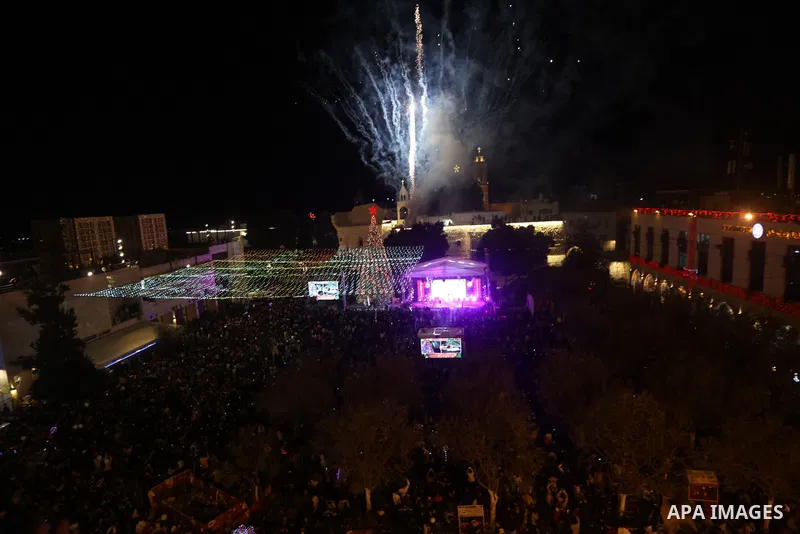 Palestinians light Christmas tree in Manger Square outside the Church of the Nativity in the West Bank city of Bethlehem on December 3, 2022. Christmas is an annual festival commemorating the birth of Jesus Christ, obser...