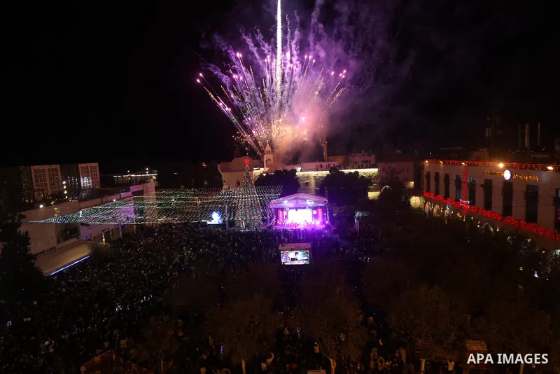 Palestinians light Christmas tree in Manger Square outside the Church of the Nativity in the West Bank city of Bethlehem on December 3, 2022. Christmas is an annual festival commemorating the birth of Jesus Christ, obser...