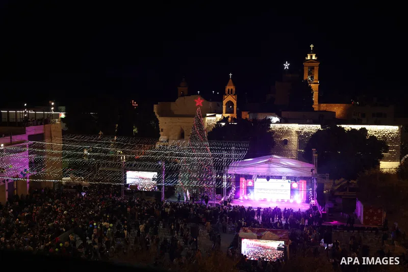 Palestinians light Christmas tree in Manger Square outside the Church of the Nativity in the West Bank city of Bethlehem on December 3, 2022. Christmas is an annual festival commemorating the birth of Jesus Christ, obser...