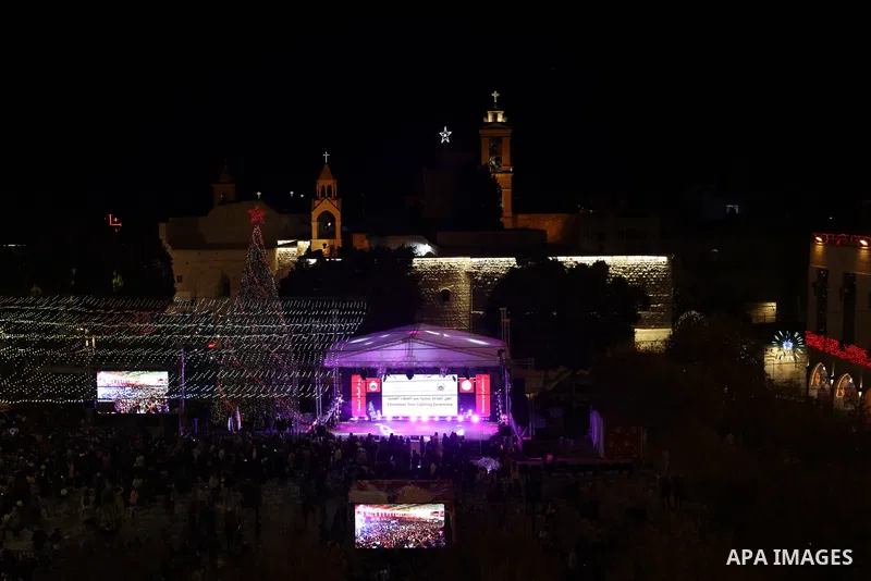 Palestinians light Christmas tree in Manger Square outside the Church of the Nativity in the West Bank city of Bethlehem on December 3, 2022. Christmas is an annual festival commemorating the birth of Jesus Christ, obser...