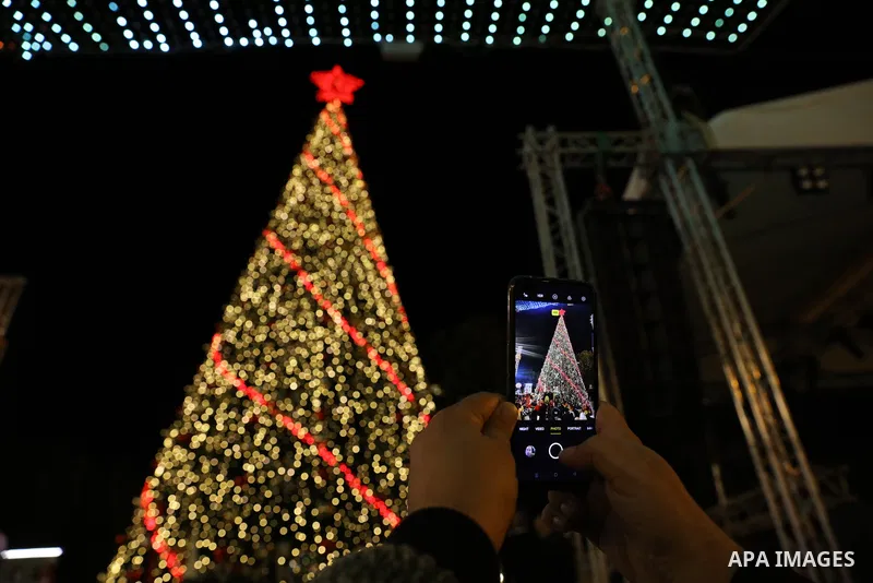 Palestinians light Christmas tree in Manger Square outside the Church of the Nativity in the West Bank city of Bethlehem on December 3, 2022. Christmas is an annual festival commemorating the birth of Jesus Christ, obser...