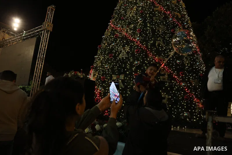 Palestinians light Christmas tree in Manger Square outside the Church of the Nativity in the West Bank city of Bethlehem on December 3, 2022. Christmas is an annual festival commemorating the birth of Jesus Christ, obser...