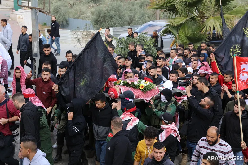 Palestinians carry the body of Omar Manaa, 22, shot dead by Israeli forces amid clashes earlier during a raid, at his funeral in the Dheisheh refugee camp near the West Bank city of Bethlehem, on December 5, 2022. Photo...