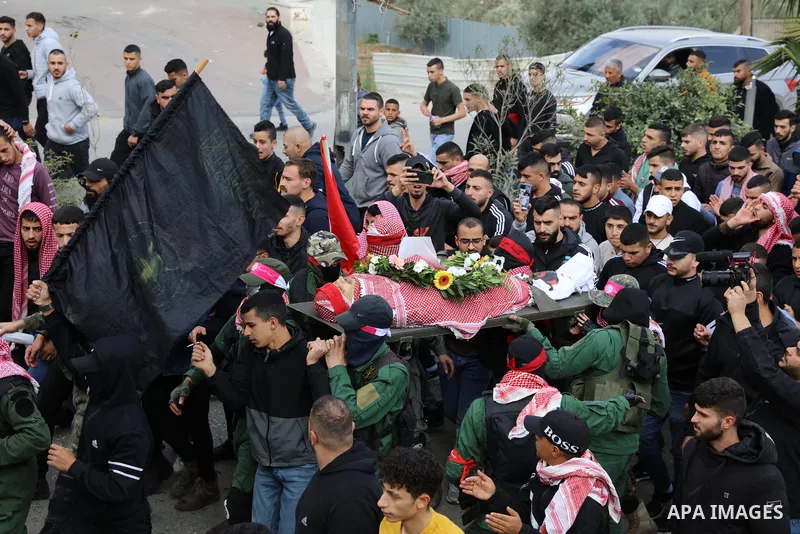 Palestinians carry the body of Omar Manaa, 22, shot dead by Israeli forces amid clashes earlier during a raid, at his funeral in the Dheisheh refugee camp near the West Bank city of Bethlehem, on December 5, 2022. Photo...