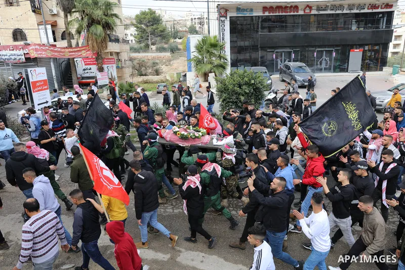 Palestinians carry the body of Omar Manaa, 22, shot dead by Israeli forces amid clashes earlier during a raid, at his funeral in the Dheisheh refugee camp near the West Bank city of Bethlehem, on December 5, 2022. Photo...