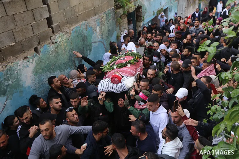 Palestinians carry the body of Omar Manaa, 22, shot dead by Israeli forces amid clashes earlier during a raid, at his funeral in the Dheisheh refugee camp near the West Bank city of Bethlehem, on December 5, 2022. Photo...