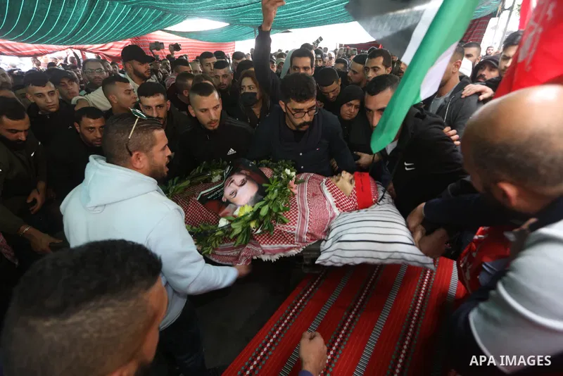 Palestinians carry the body of Omar Manaa, 22, shot dead by Israeli forces amid clashes earlier during a raid, at his funeral in the Dheisheh refugee camp near the West Bank city of Bethlehem, on December 5, 2022. Photo...