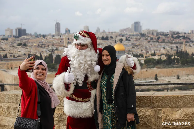 Palestinian Issa Kassissieh, dressed as Santa Claus, poses for a picture at the Mount of Olives in Jerusalem, a few weeks before the upcoming holiday of Christmas on December 6, 2022. In Jerusalem's Old City there are do...