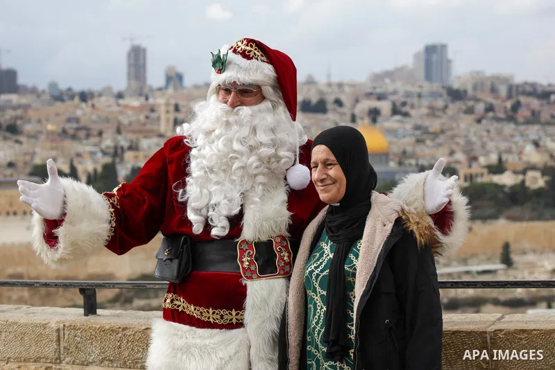 Palestinian Issa Kassissieh, dressed as Santa Claus, poses for a picture at the Mount of Olives in Jerusalem, a few weeks before the upcoming holiday of Christmas on December 6, 2022. In Jerusalem's Old City there are do...