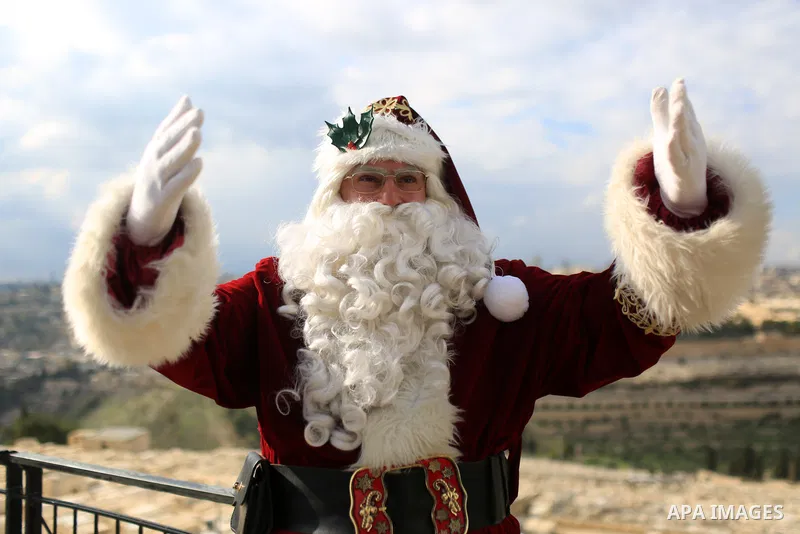 Palestinian Issa Kassissieh, dressed as Santa Claus, poses for a picture at the Mount of Olives in Jerusalem, a few weeks before the upcoming holiday of Christmas on December 6, 2022. In Jerusalem's Old City there are do...