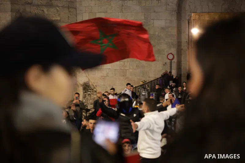 Palestinian celebrate historic victory over Portugal in a 2022 FIFA World Cup match, in the Old City of Jerusalem, December 10,2022. Photo by Saeed Qaq\ apaimages