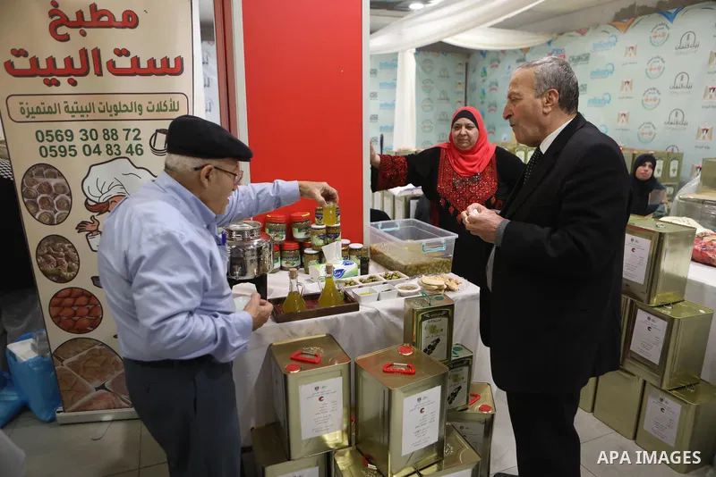 Palestinians attend the Third National Olive Festival in the West Bank city of Hebron on December 10, 2022. The olive harvest is a main source of income for thousands of Palestinian households. Photo by Mamoun Wazwaz
