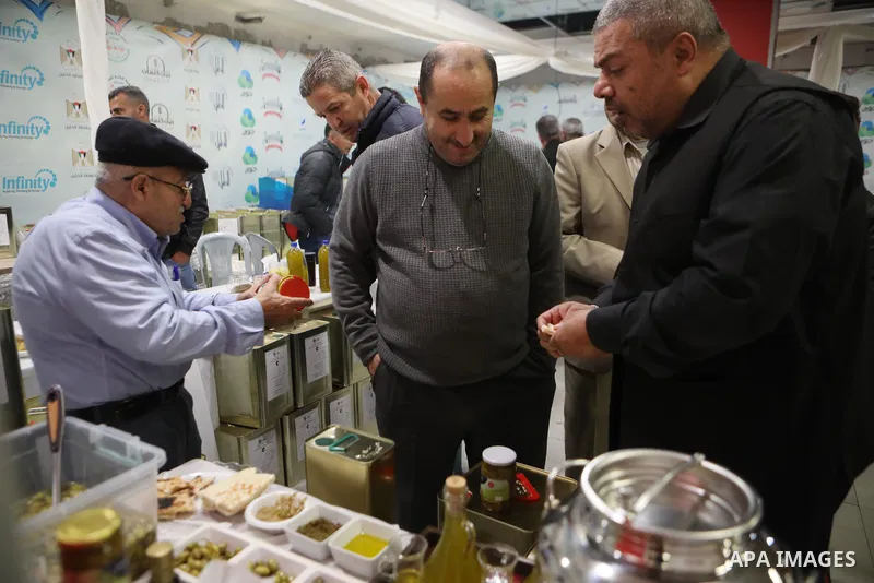 Palestinians attend the Third National Olive Festival in the West Bank city of Hebron on December 10, 2022. The olive harvest is a main source of income for thousands of Palestinian households. Photo by Mamoun Wazwaz