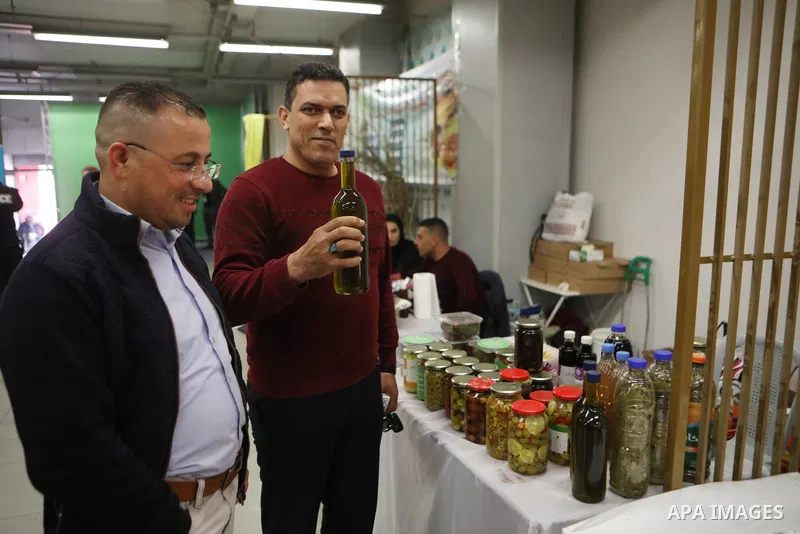 Palestinians attend the Third National Olive Festival in the West Bank city of Hebron on December 10, 2022. The olive harvest is a main source of income for thousands of Palestinian households. Photo by Mamoun Wazwaz