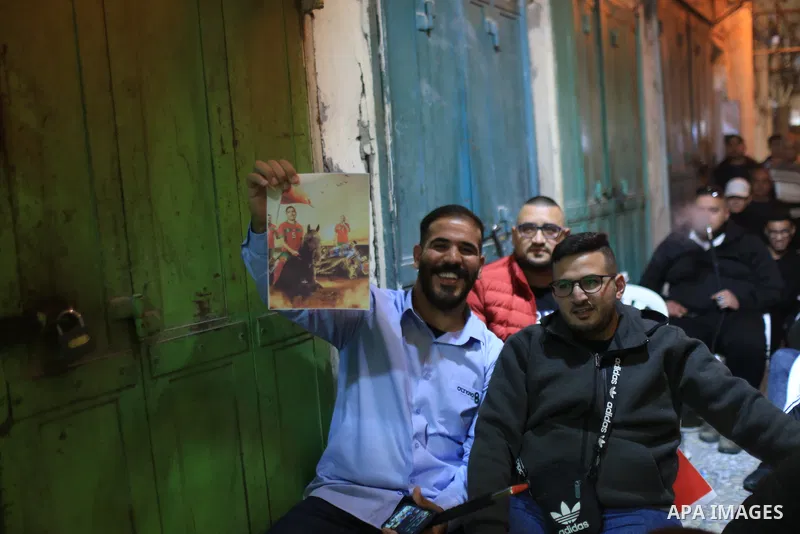 Palestinian fans gather to attend Morocco vs Portugal match in the Bashoura Market, one of the markets in the Old City of Jerusalem on December 10, 2022. Photo by Saeed Qaq\ apaimages