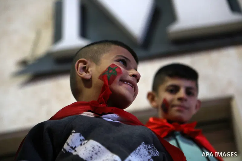 Palestinian football fans react as they watch on a large screen the Qatar World Cup 2022 semi-final football match between Morocco and France, in the West Bank city of Hebron on December 14, 2022. Photo by Mamoun Wazwaz/...