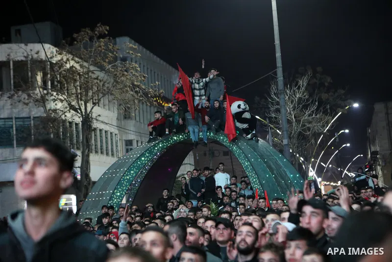 Palestinian football fans react as they watch on a large screen the Qatar World Cup 2022 semi-final football match between Morocco and France, in the West Bank city of Hebron on December 14, 2022. Photo by Mamoun Wazwaz/...