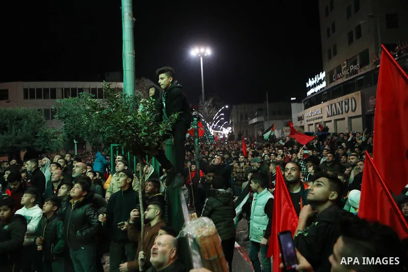 Palestinian football fans react as they watch on a large screen the Qatar World Cup 2022 semi-final football match between Morocco and France, in the West Bank city of Hebron on December 14, 2022. Photo by Mamoun Wazwaz/...
