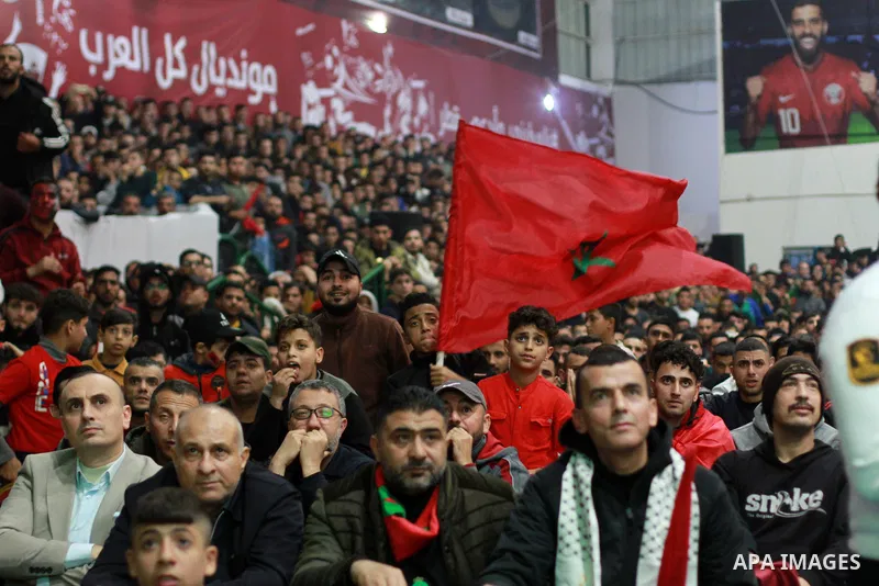 Palestinian football fans react as they watch on a large screen the Qatar World Cup 2022 semi-final football match between Morocco and France, in Gaza city on December 14, 2022. Photo by Ali Hamad\ apaimages