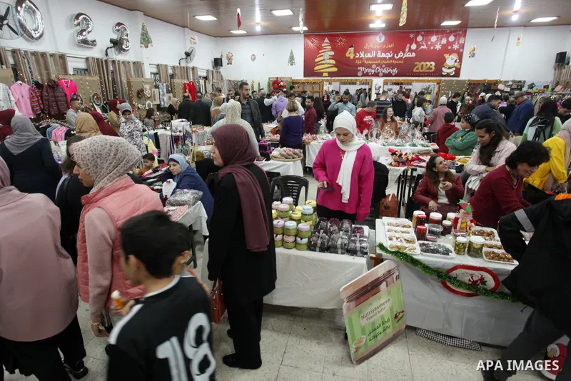 Palestinians participate in the fourth "Christmas Star" fair for handicrafts a few weeks before the upcoming holiday of Christmas, in Gaza city on December 15, 2022. Christmas is an annual festival commemorating the birt...