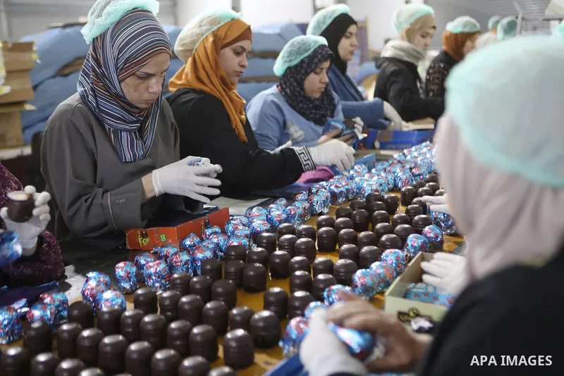 Palestinian workers prepare the vanilla candy known as "Ras El-abed or Shatawi" at a factory in the West Bank city Hebron on December 15, 2022. “Ras el Abed” means “Head of Slave”. We would often laugh about how racist t...