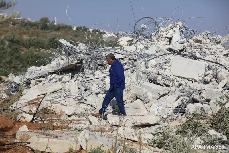 Palestinians inspect the rubble of houses which were demolished by the Israeli army in the village of Elmenia, to the south of the West Bank city of Bethlehem, on November 14, 2022. The Israeli army demolished this morni...