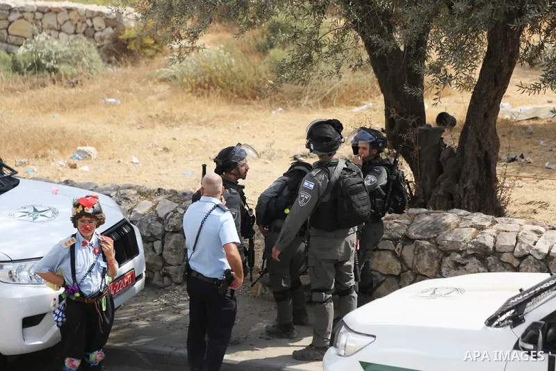 Palestinians argue with Israeli policemen who prevent them picking olives in the Arab neighbourhood of Silwan in Israel-annexed eastern Jerusalem amid Israeli calls for the control of Arab lands and olive picking by sett...
