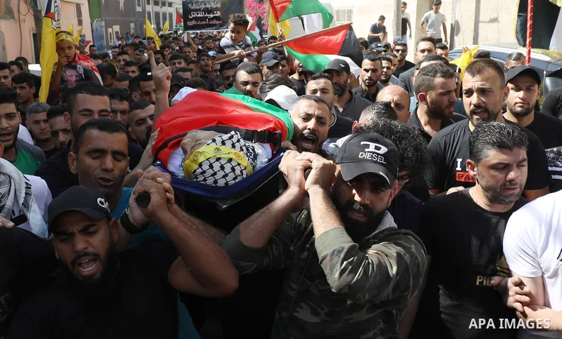 Palestinians carry the body of Mujahid Daoud, 30, who died of a wound he sustained during clashes with Israeli forces during funeral in West Bank city of Salfit on October 16, 2022. Photo by Wajed Nobani