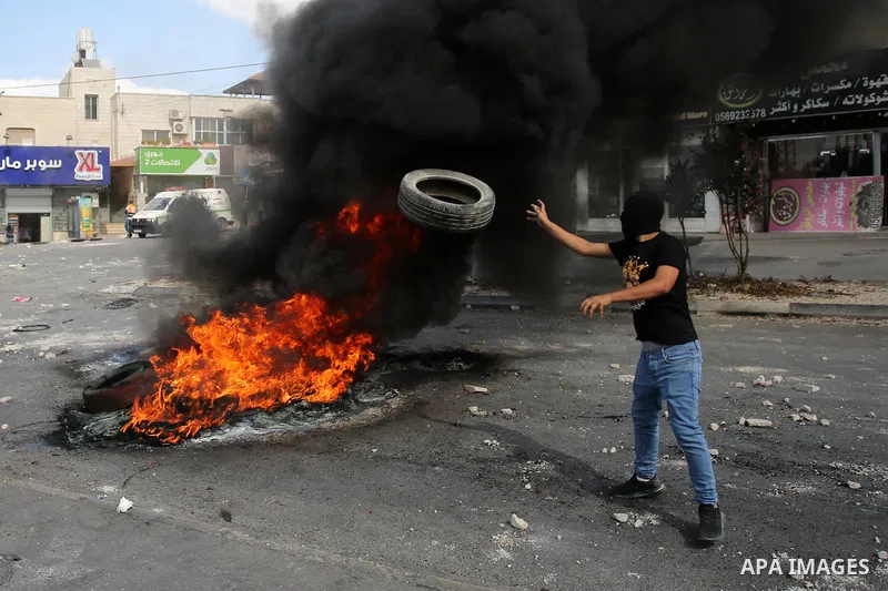 Palestinian protesters clash with Israeli forces in the village of Deir Sharaf near the western entrance of the city of Nablus in the West Bank on October 20, 2022, as Palestinian protesters attempt to remove a barrier e...