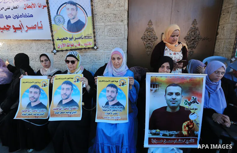 Palestinians take part in a protest in solidarity with a cancer sick prisoner Nasser Abu Hamid at Israeli jails, in front of Red Cross office in Gaza city on September 29, 2022. Hundreds of Palestinians marched today dem...