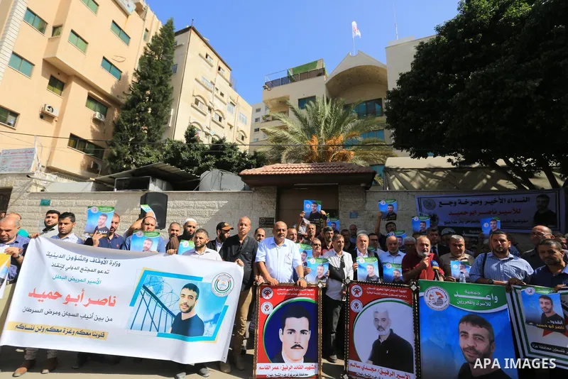 Palestinians take part in a protest in solidarity with a cancer sick prisoner Nasser Abu Hamid at Israeli jails, in front of Red Cross office in Gaza city on September 29, 2022. Hundreds of Palestinians marched today dem...