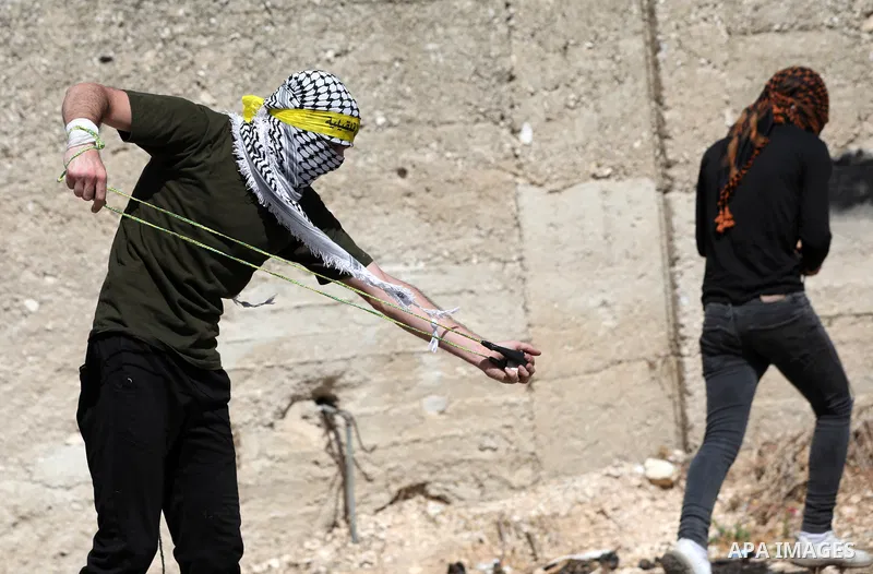 Palestinian demonstrators clash with Israeli forces, following a protest against the expropriation of Palestinian land by Israel, in the West Bank village of Kfar Qaddum near the Jewish settlement of Kedumim, on Septembe...