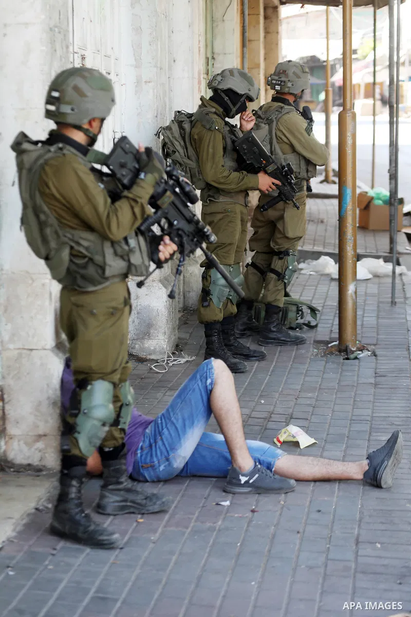 Israeli forces detain three Palestinian youths during clashes following a demonstration against settlements, in the West Bank city of Hebron on August 26, 2022. Photo by Mamoun Wazwaz/APAimages