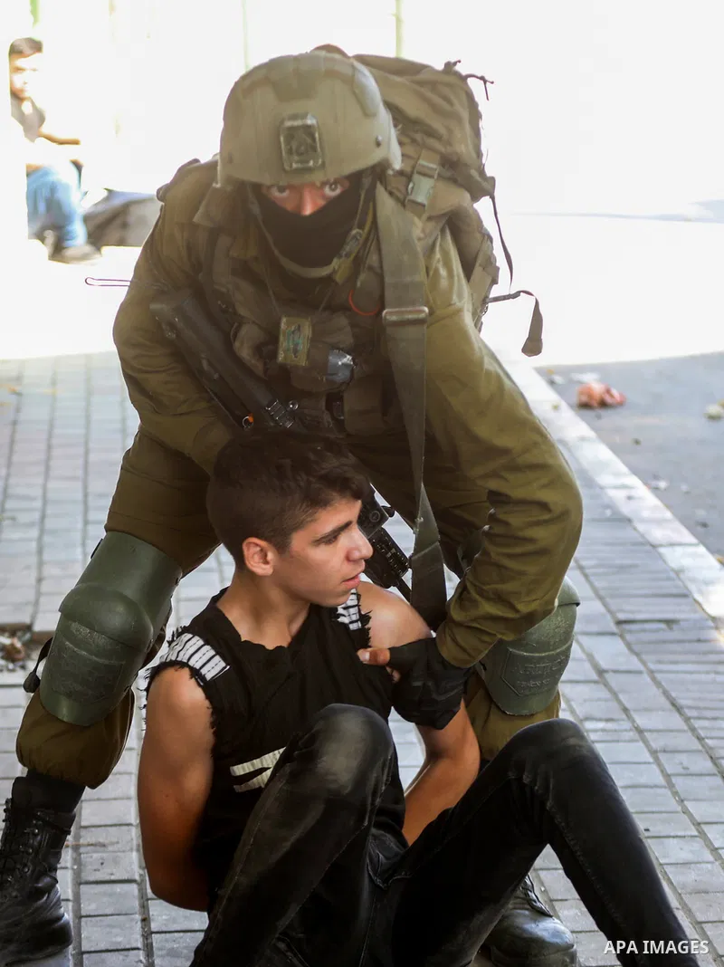 Israeli forces detain three Palestinian youths during clashes following a demonstration against settlements, in the West Bank city of Hebron on August 26, 2022. Photo by Mamoun Wazwaz/APAimages