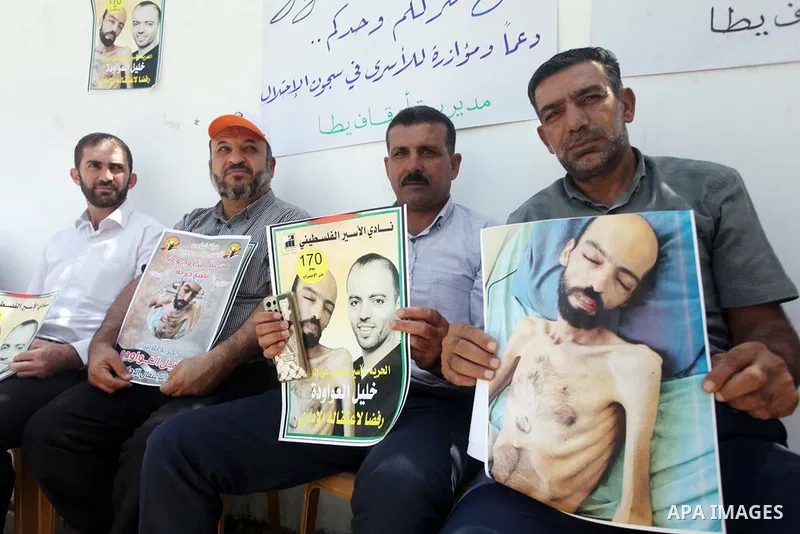 Palestinians take part in a protest in solidarity with prisoner on hunger strike in Israeli jails Khalil Awawda, in front of Red Cross office, in the West Bank city of Hebron on August 29, 2022. After around six months o...