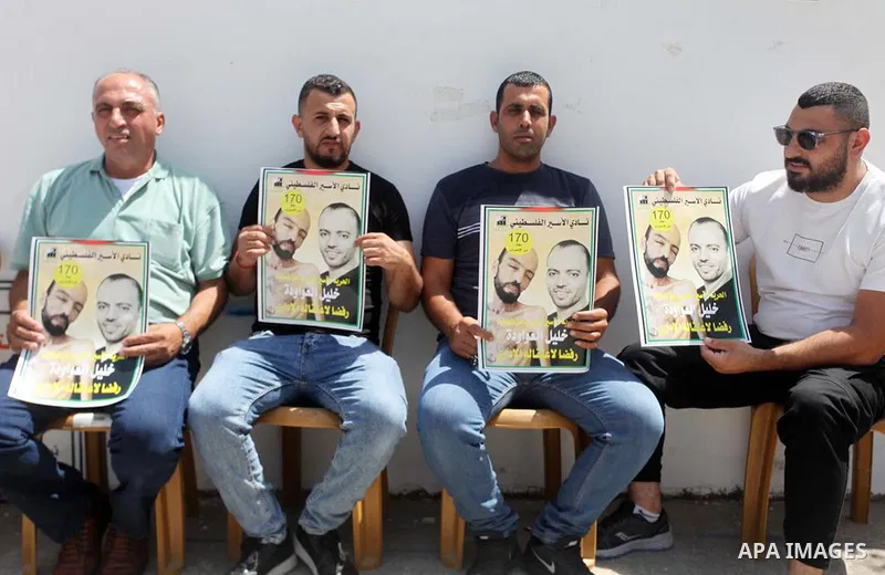 Palestinians take part in a protest in solidarity with prisoner on hunger strike in Israeli jails Khalil Awawda, in front of Red Cross office, in the West Bank city of Hebron on August 29, 2022. After around six months o...